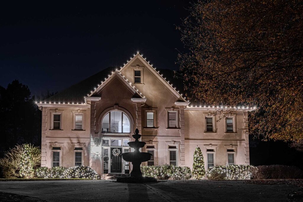 Precision roofline Christmas light installation on a luxury home